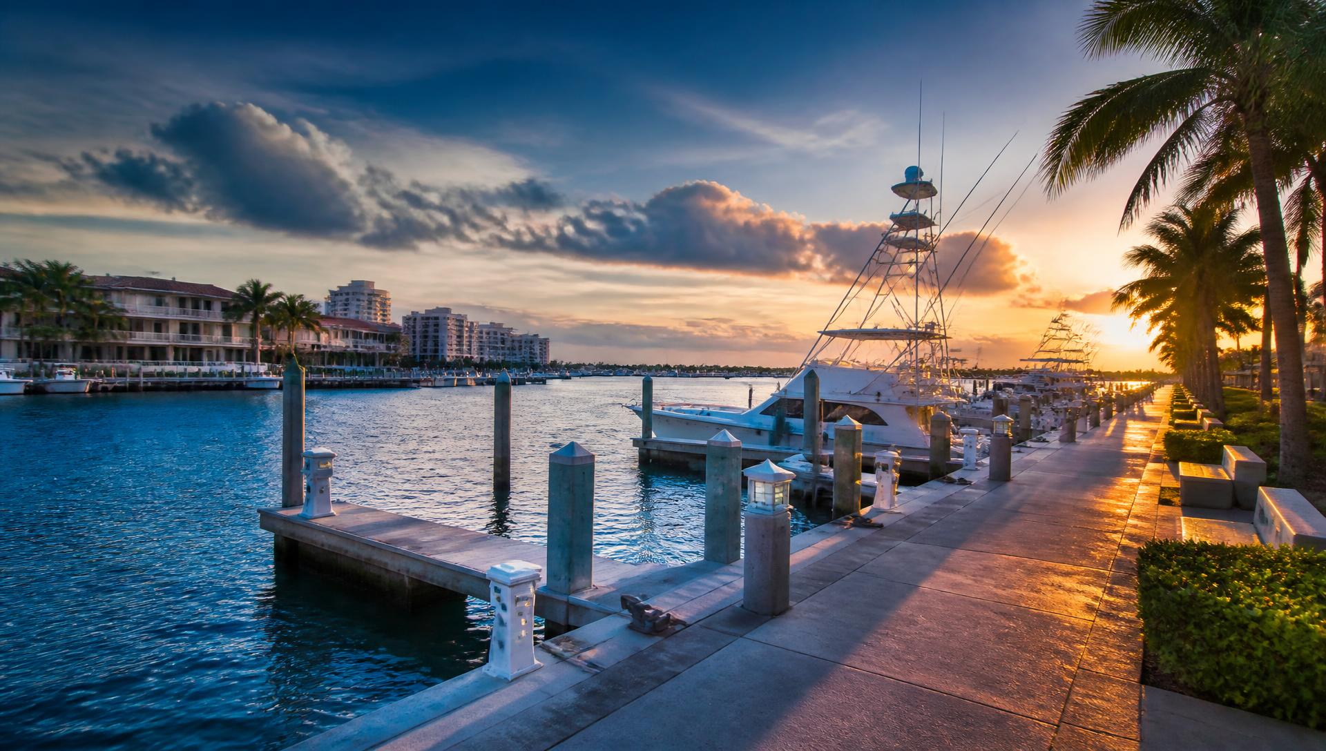 South Florida marina with concrete waterfront walkway at golden hour